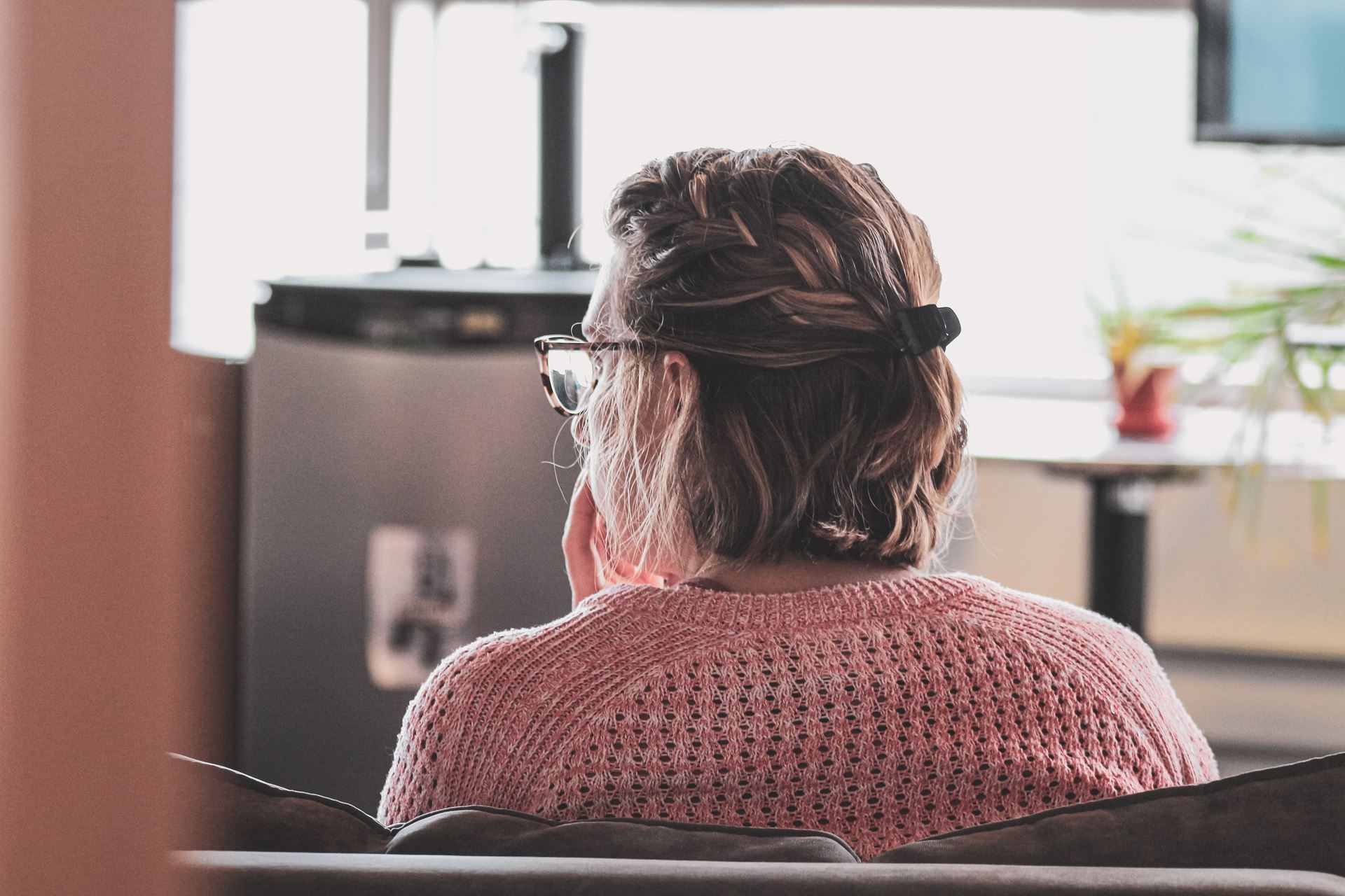 back of a woman's head; she is thinking