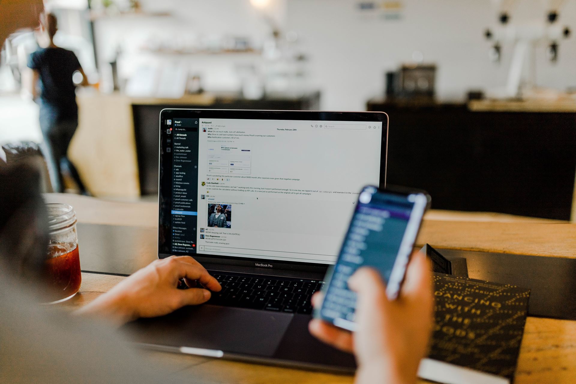 a person using a laptop and smartphone